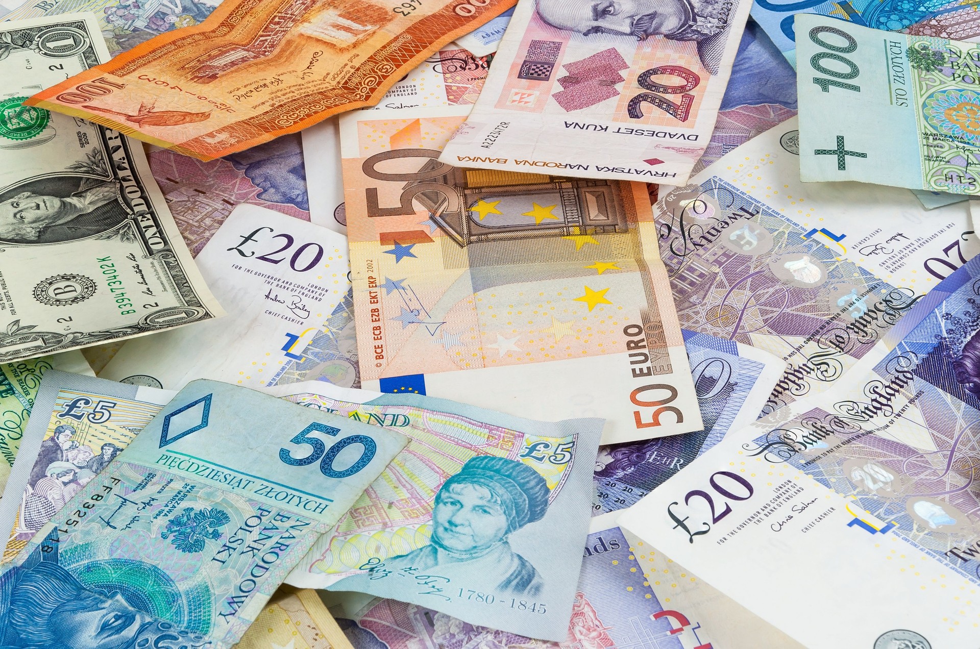 Different currencies banknotes background